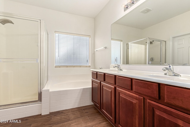 bathroom featuring hardwood / wood-style floors, vanity, plenty of natural light, and independent shower and bath