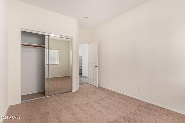 unfurnished bedroom with a closet and carpet floors