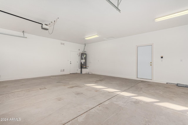 garage with a garage door opener and water heater