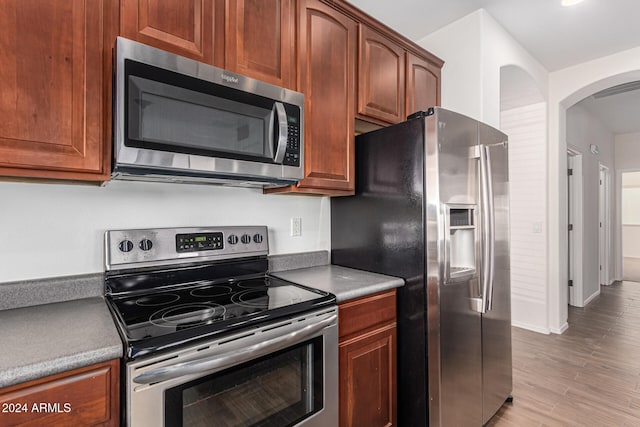 kitchen with stainless steel appliances and light hardwood / wood-style floors