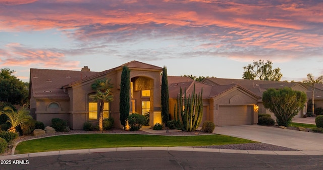 view of front of property with a yard and a garage