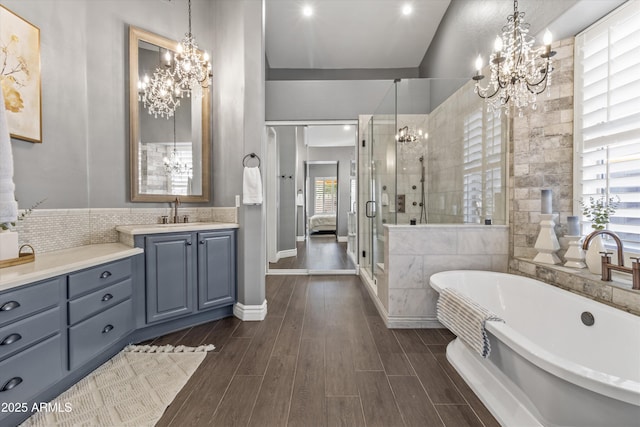 bathroom featuring vanity and separate shower and tub