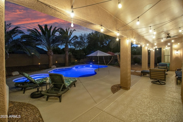 pool at dusk featuring a patio area