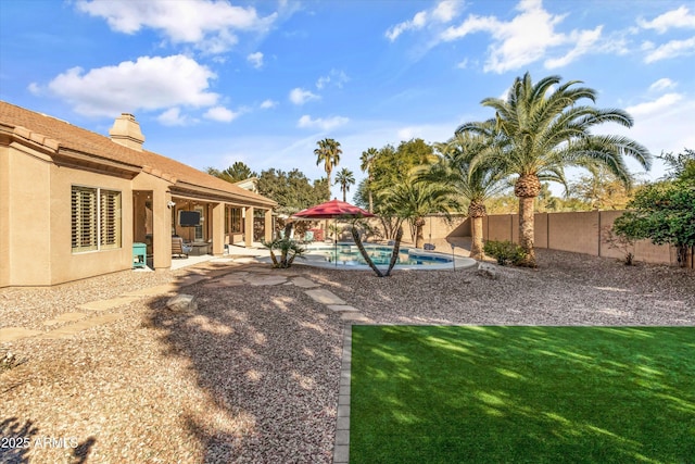 view of yard with a patio and a fenced in pool