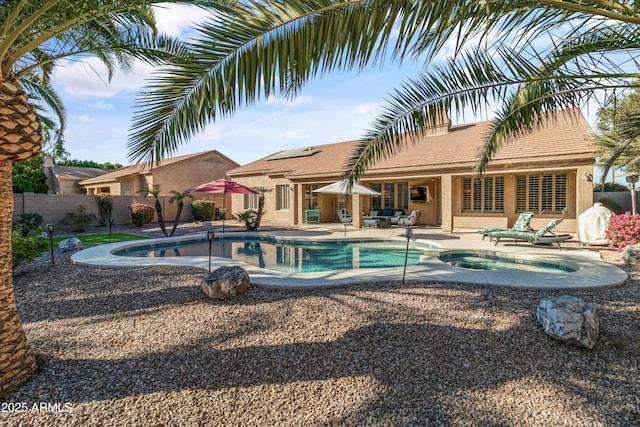 view of pool with an in ground hot tub and a patio area