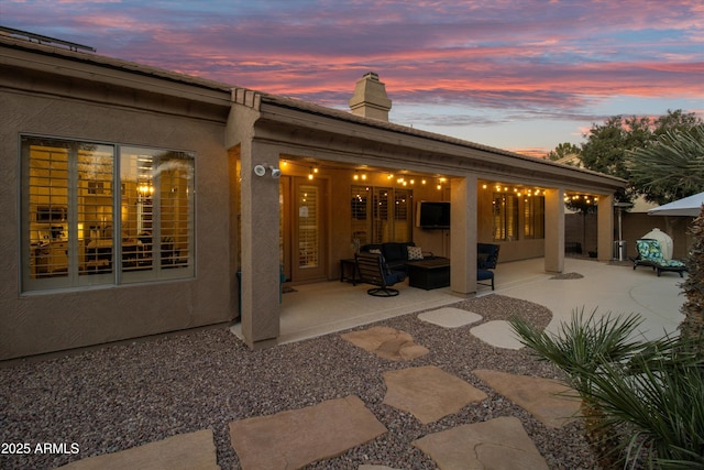 back of house featuring a patio area and outdoor lounge area