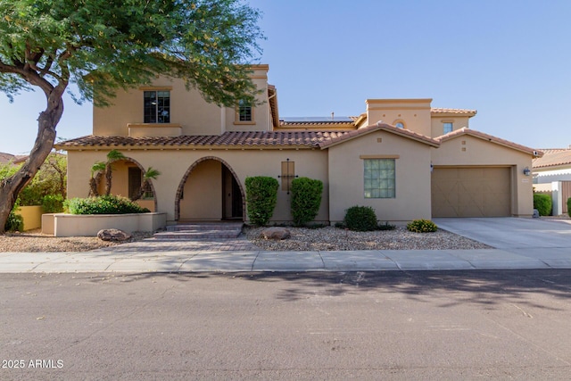 16178 W Granada Rd, Goodyear, AZ 85395 - mediterranean / spanish-style home with stucco siding, driveway, a garage, solar panels, and a tiled roof