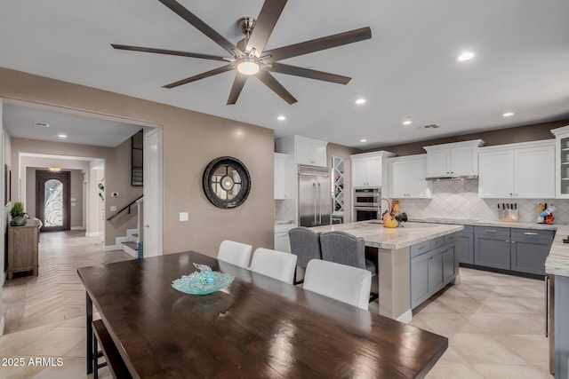 16178 W Granada Rd, Goodyear, AZ 85395 - dining room with stairs, a ceiling fan, and recessed lighting