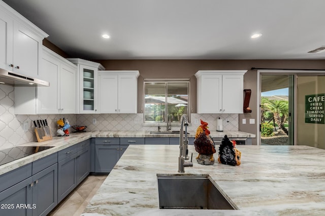 16178 W Granada Rd, Goodyear, AZ 85395 - kitchen featuring ventilation hood, black electric cooktop, healthy amount of natural light, white cabinets, and recessed lighting