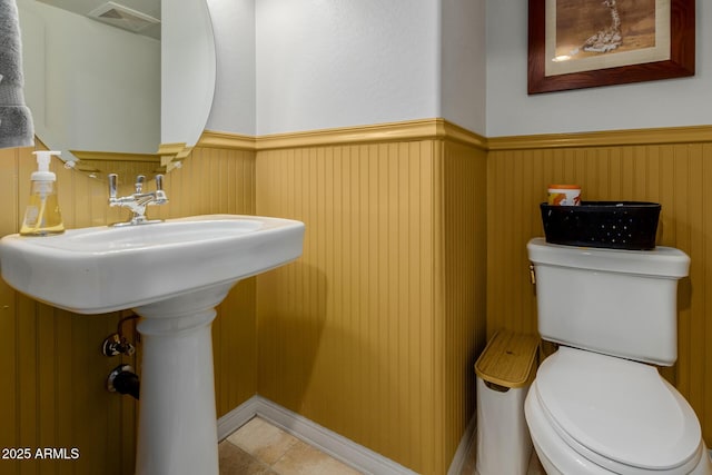 16178 W Granada Rd, Goodyear, AZ 85395 - half bathroom featuring a wainscoted wall and toilet