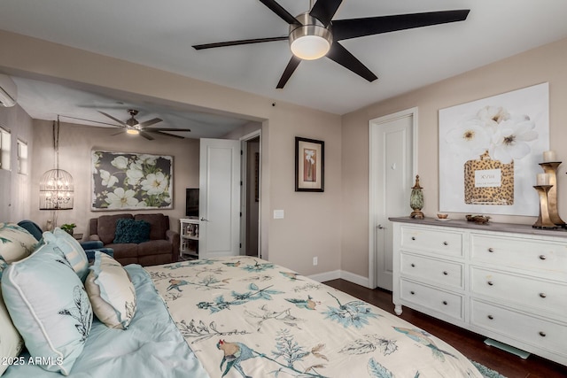 16178 W Granada Rd, Goodyear, AZ 85395 - bedroom with dark wood finished floors, a chandelier, a wall mounted air conditioner, and a ceiling fan