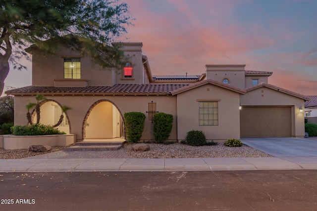 16178 W Granada Rd, Goodyear, AZ 85395 - mediterranean / spanish house with concrete driveway, solar panels, stucco siding, and an attached garage