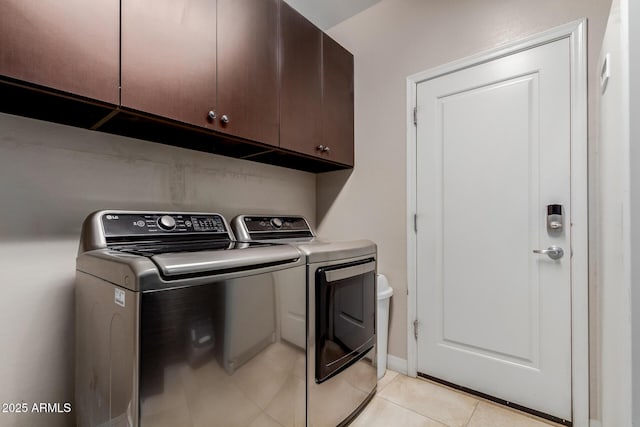 16178 W Granada Rd, Goodyear, AZ 85395 - washroom featuring cabinet space, washer and dryer, and light tile patterned floors