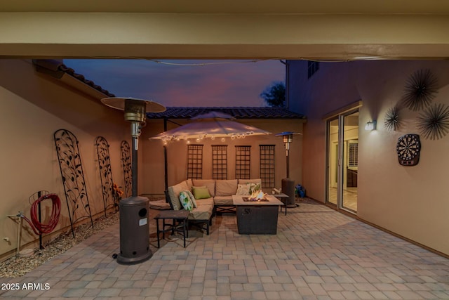 16178 W Granada Rd, Goodyear, AZ 85395 - patio terrace at dusk featuring an outdoor living space with a fire pit and a patio