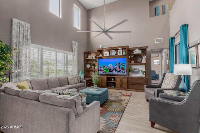 16178 W Granada Rd, Goodyear, AZ 85395 - living room with a high ceiling, a ceiling fan, and wood finished floors