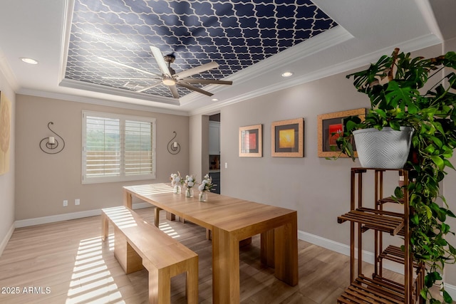 16178 W Granada Rd, Goodyear, AZ 85395 - dining room featuring a raised ceiling, a ceiling fan, light wood-style flooring, ornamental molding, and recessed lighting