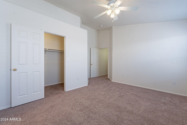 unfurnished bedroom featuring ceiling fan, a closet, and carpet