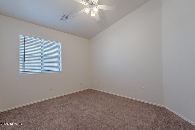 carpeted spare room featuring lofted ceiling and ceiling fan