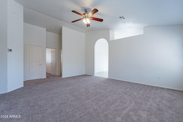 carpeted spare room featuring ceiling fan