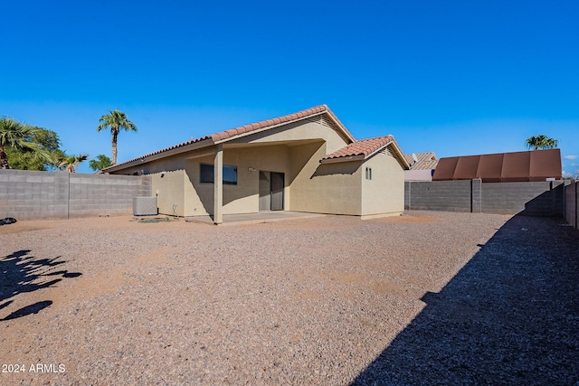 back of house featuring central AC