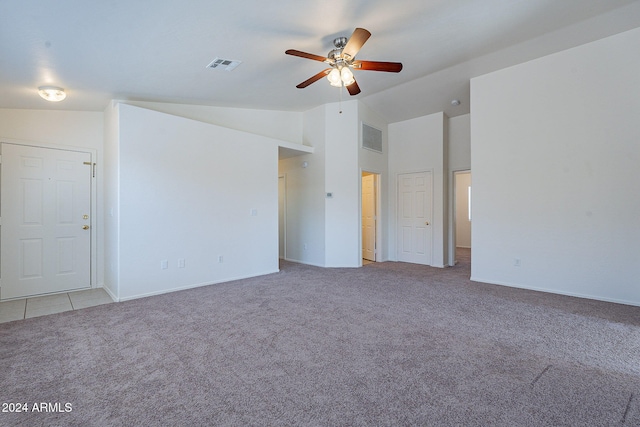 spare room featuring lofted ceiling, light carpet, and ceiling fan