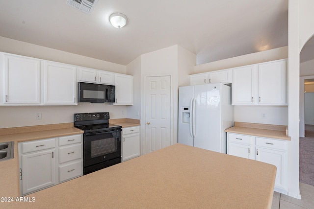 kitchen featuring black appliances, light colored carpet, and white cabinets