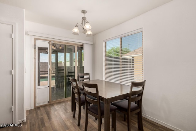 910 W Prior Ave, Coolidge, AZ 85128 - dining space featuring a chandelier, dark wood-style flooring, and baseboards