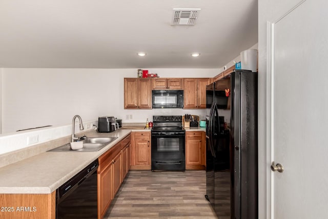 910 W Prior Ave, Coolidge, AZ 85128 - kitchen with black appliances, a sink, light wood-style floors, light countertops, and recessed lighting