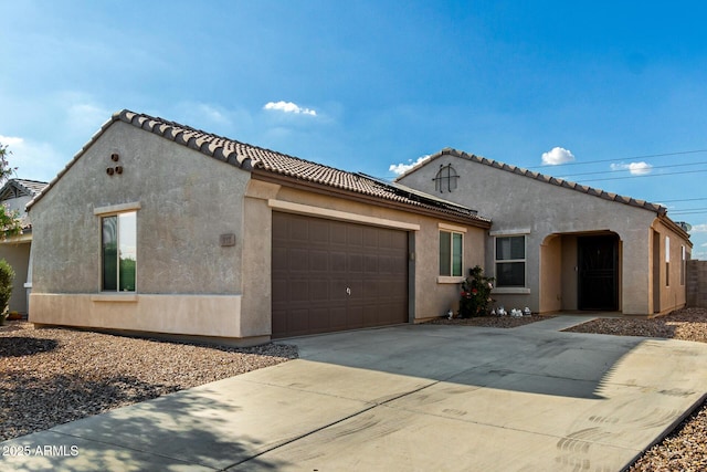 910 W Prior Ave, Coolidge, AZ 85128 - mediterranean / spanish house with a garage, concrete driveway, stucco siding, and a tile roof