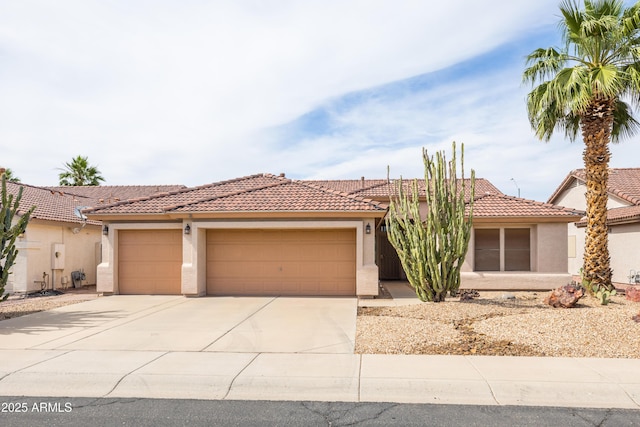 4020 W Menadota Dr, Glendale, AZ 85308 - view of front of house featuring concrete driveway, stucco siding, and a tile roof