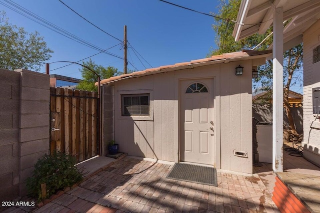 view of shed featuring fence