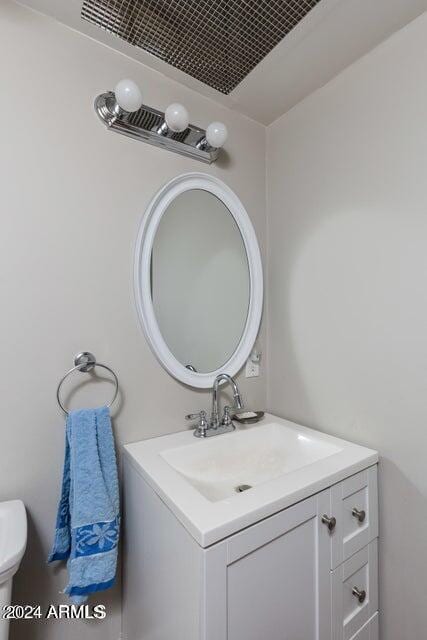half bathroom featuring toilet and vanity