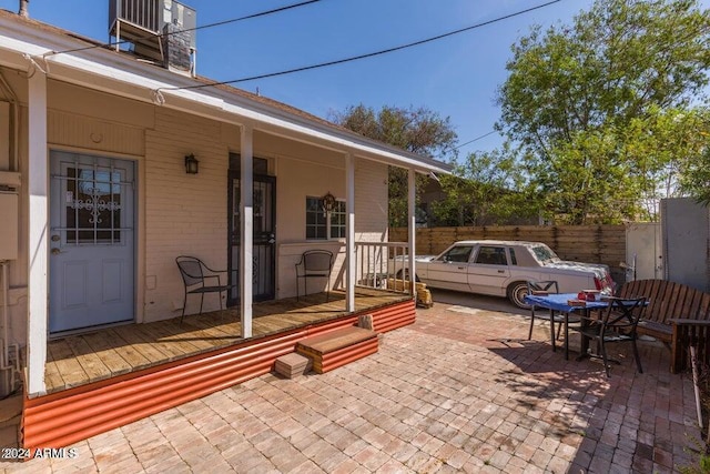 view of patio / terrace with outdoor dining space, cooling unit, and fence