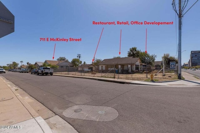 view of street featuring curbs, a residential view, and sidewalks