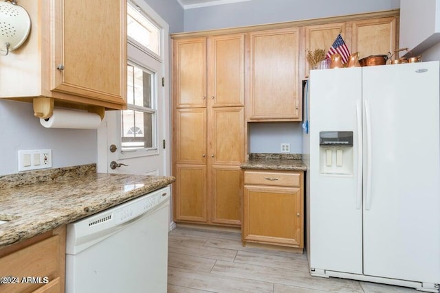 kitchen featuring white appliances, wood tiled floor, and light stone counters