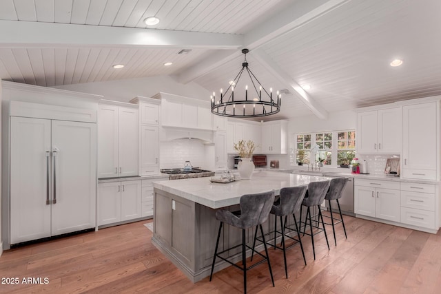 6196 E Calle Camelia, Scottsdale, AZ 85251 - kitchen featuring paneled built in refrigerator, a kitchen island, recessed lighting, a chandelier, and white cabinetry