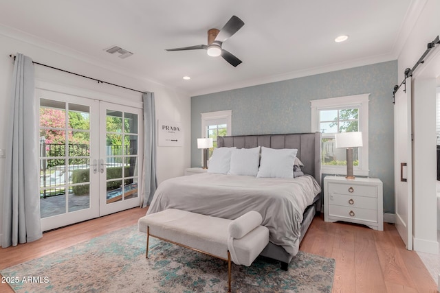 6196 E Calle Camelia, Scottsdale, AZ 85251 - bedroom with a barn door, access to exterior, wood finished floors, crown molding, and french doors