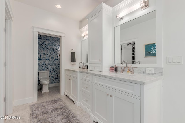 6196 E Calle Camelia, Scottsdale, AZ 85251 - bathroom with toilet, baseboards, and double vanity
