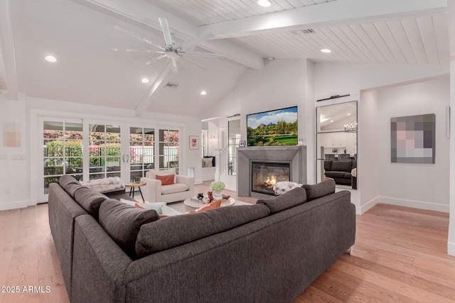 6196 E Calle Camelia, Scottsdale, AZ 85251 - living room featuring baseboards, beamed ceiling, light wood-type flooring, recessed lighting, and a glass covered fireplace