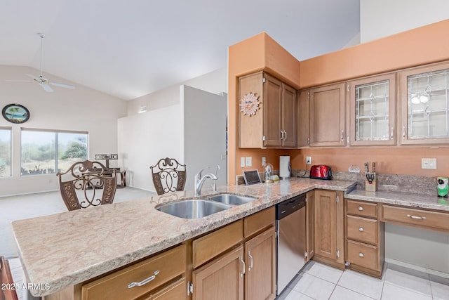 kitchen with sink, vaulted ceiling, light tile patterned floors, stainless steel dishwasher, and kitchen peninsula