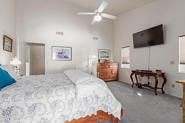 bedroom with high vaulted ceiling, ceiling fan, and carpet