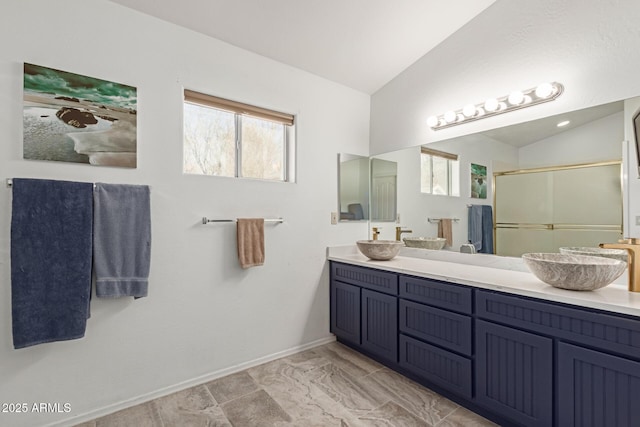 bathroom featuring vanity, an enclosed shower, and vaulted ceiling