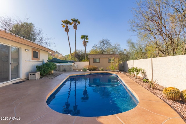 view of pool featuring an outdoor structure and a patio area