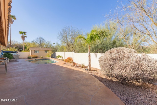 view of patio / terrace featuring a fenced in pool and an outdoor structure