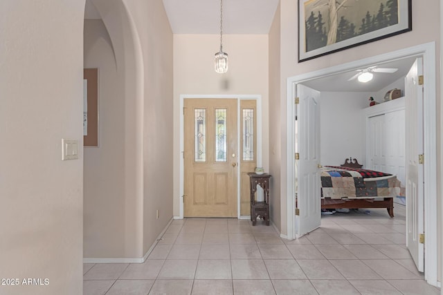 tiled entryway with a high ceiling