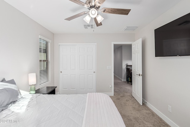 carpeted bedroom with a closet and ceiling fan