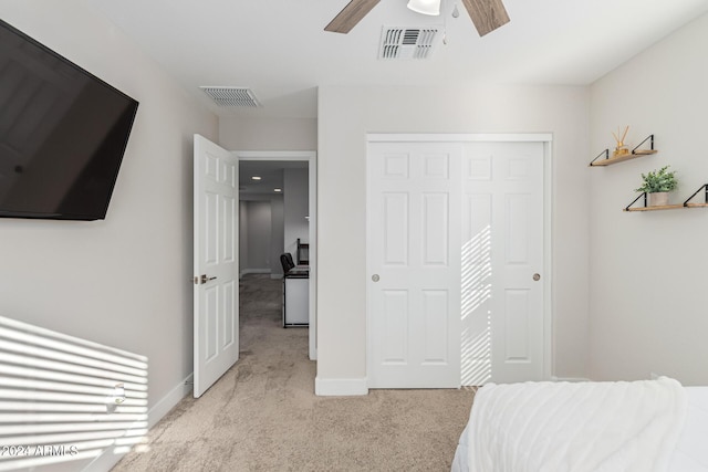 carpeted bedroom featuring a closet and ceiling fan