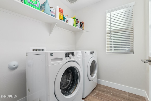 clothes washing area featuring washer and dryer