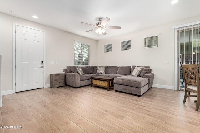 living room featuring ceiling fan and light wood-type flooring