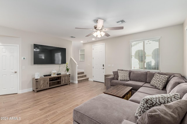 living room featuring ceiling fan and light wood-type flooring